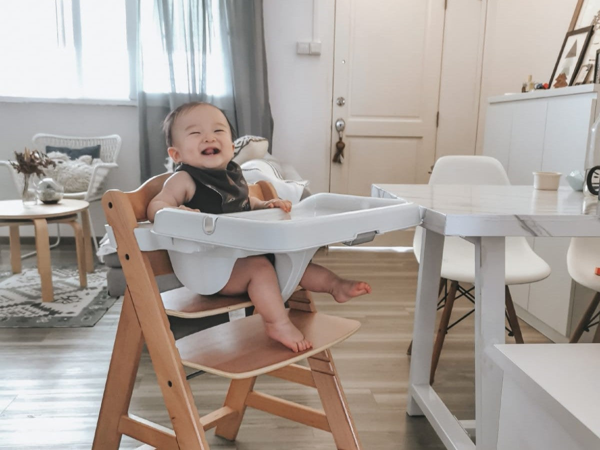 baby in feeding high chair 