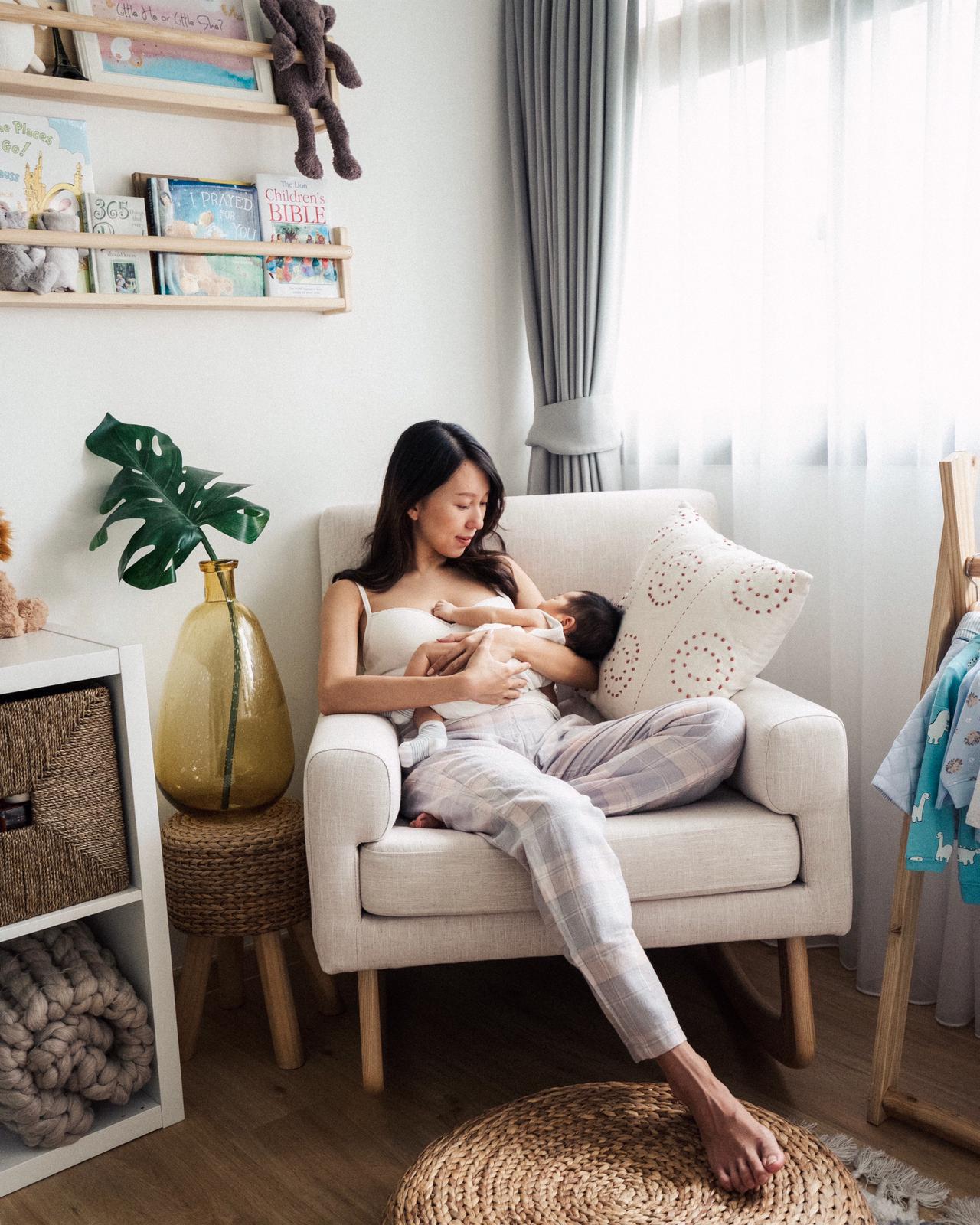 Mum carrying baby on the sleepytime nursing chair