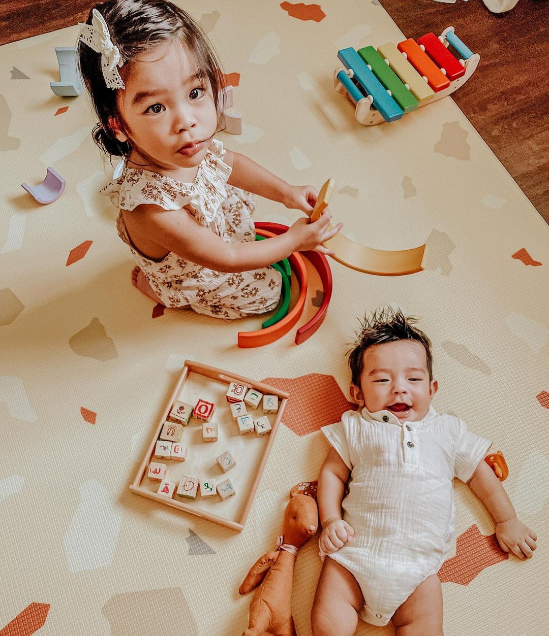 baby and child on playmat