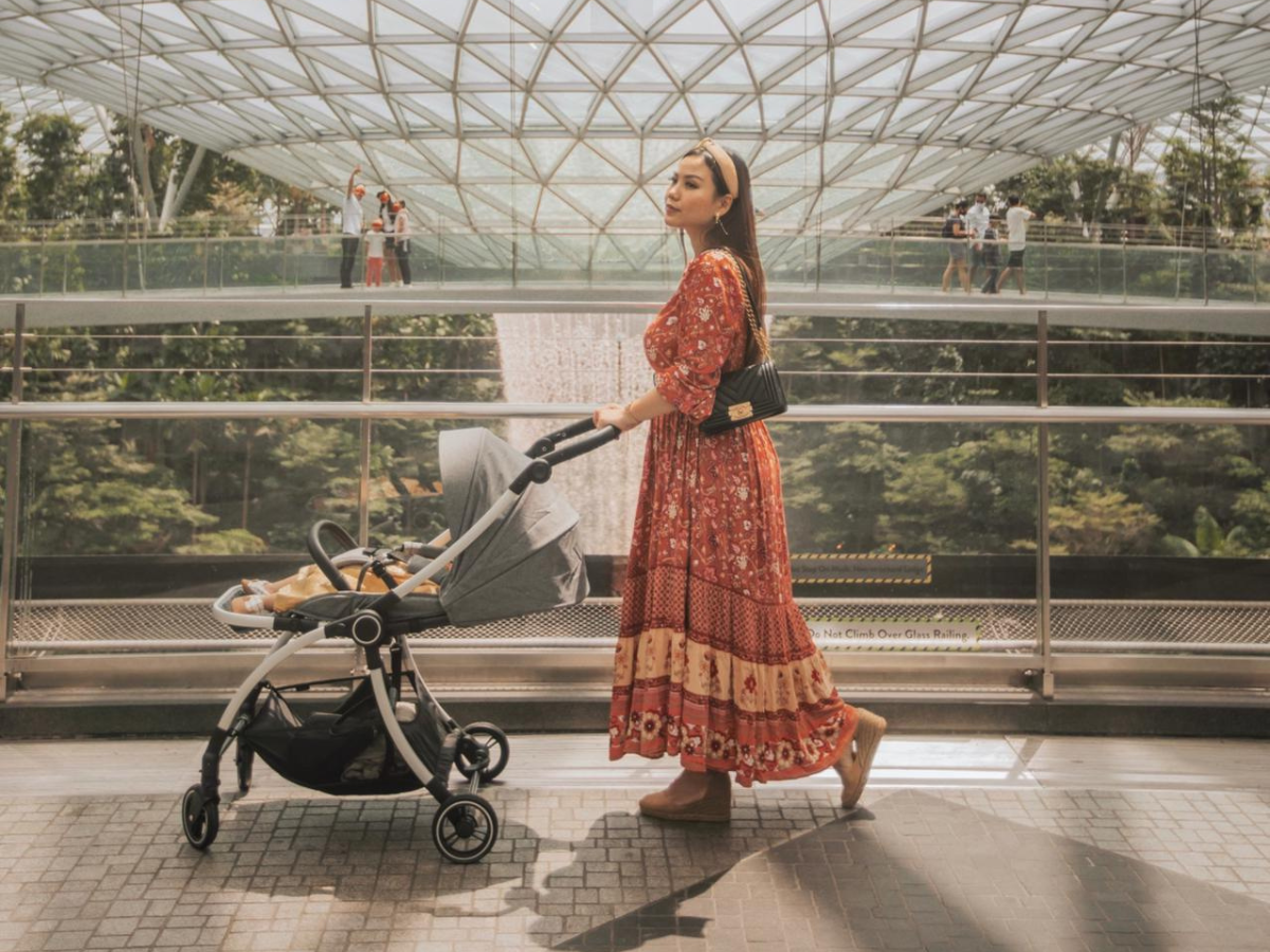 mum taking a walk in the mall with baby in the stroller