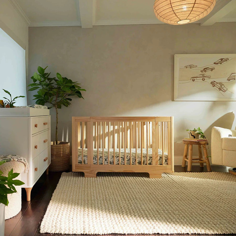 Baby crib, dresser, and nursing chair displayed in a nursery