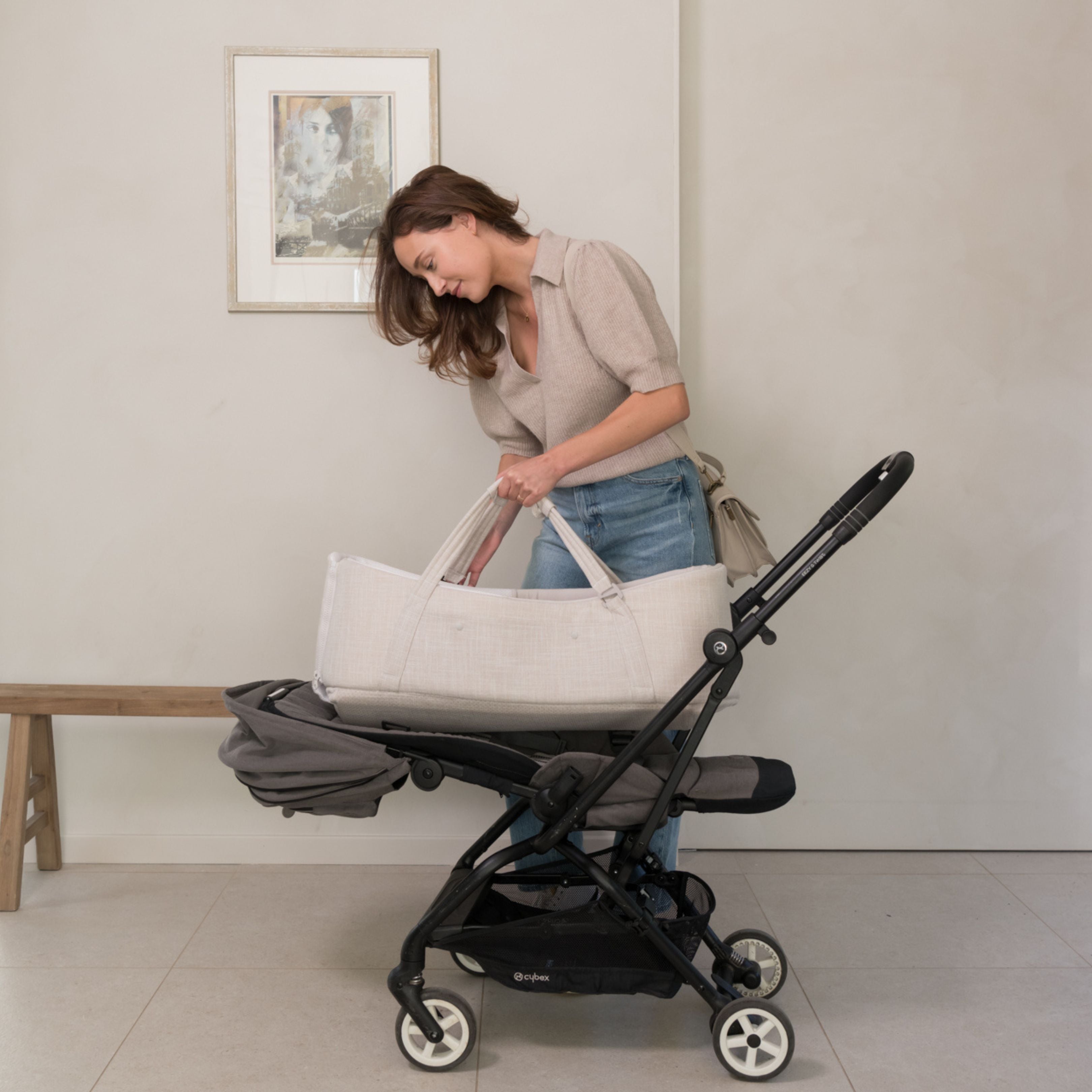 mum putting the doomoo nest n go on a stroller seat unit