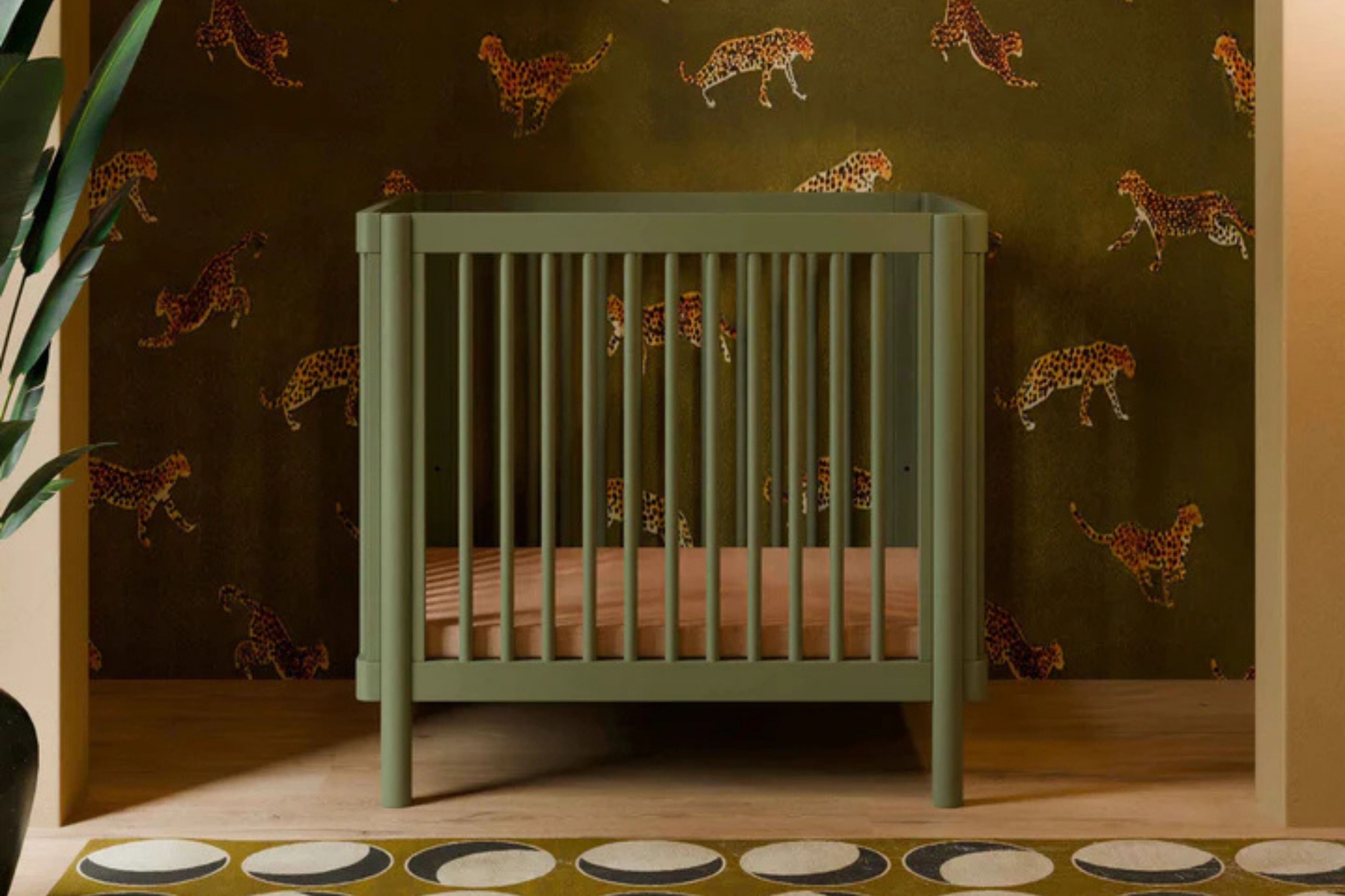 Babyletto olive pogo 8-in-1-convertible crib midi in a nursery#color_olive