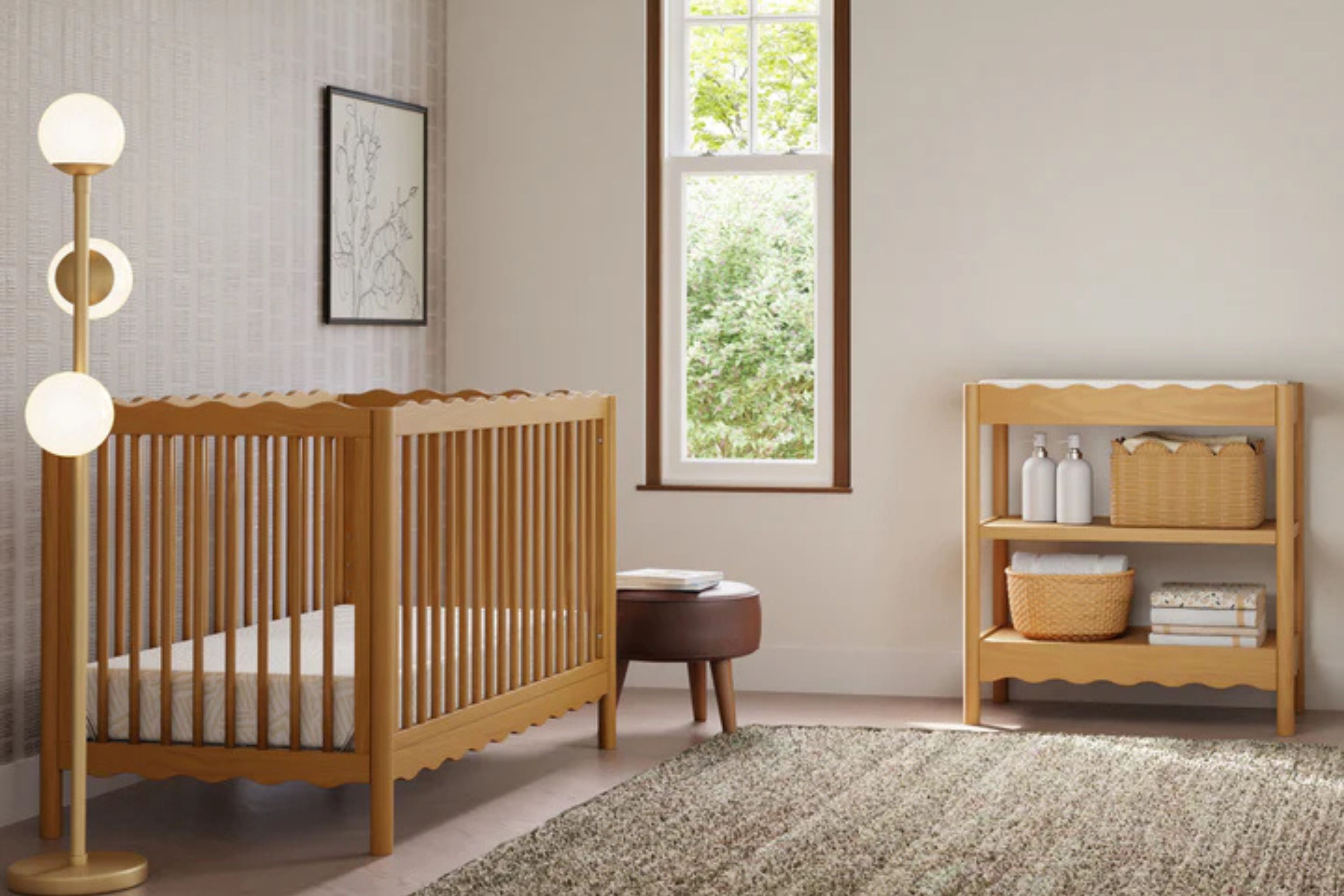 Babyletto swell changing table honey displayed in the nursery with the matching swell convertible crib overview #color_honey