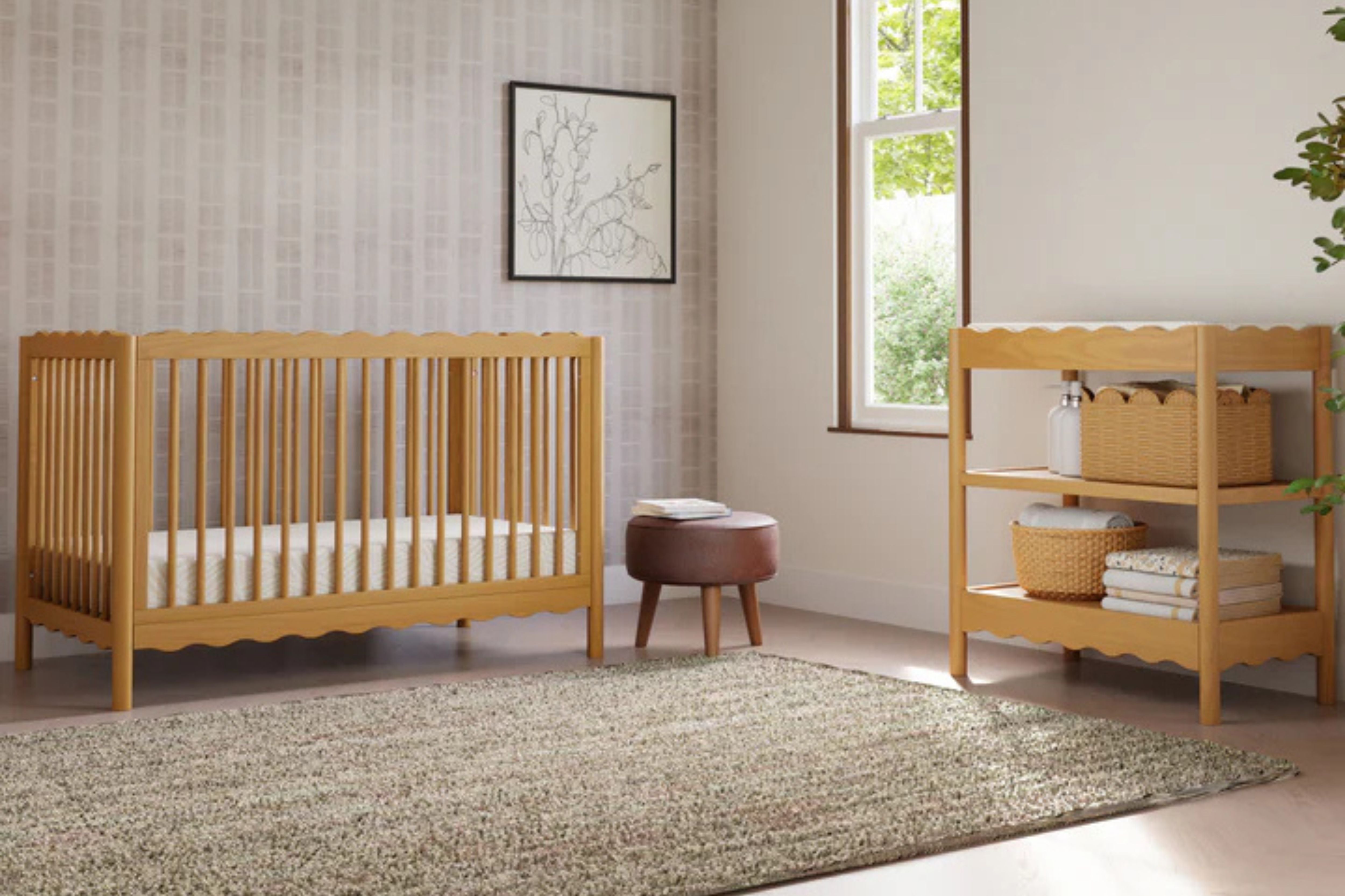 babyletto swell convertible crib honey in a nursery with the matching swell changing table#color_honey