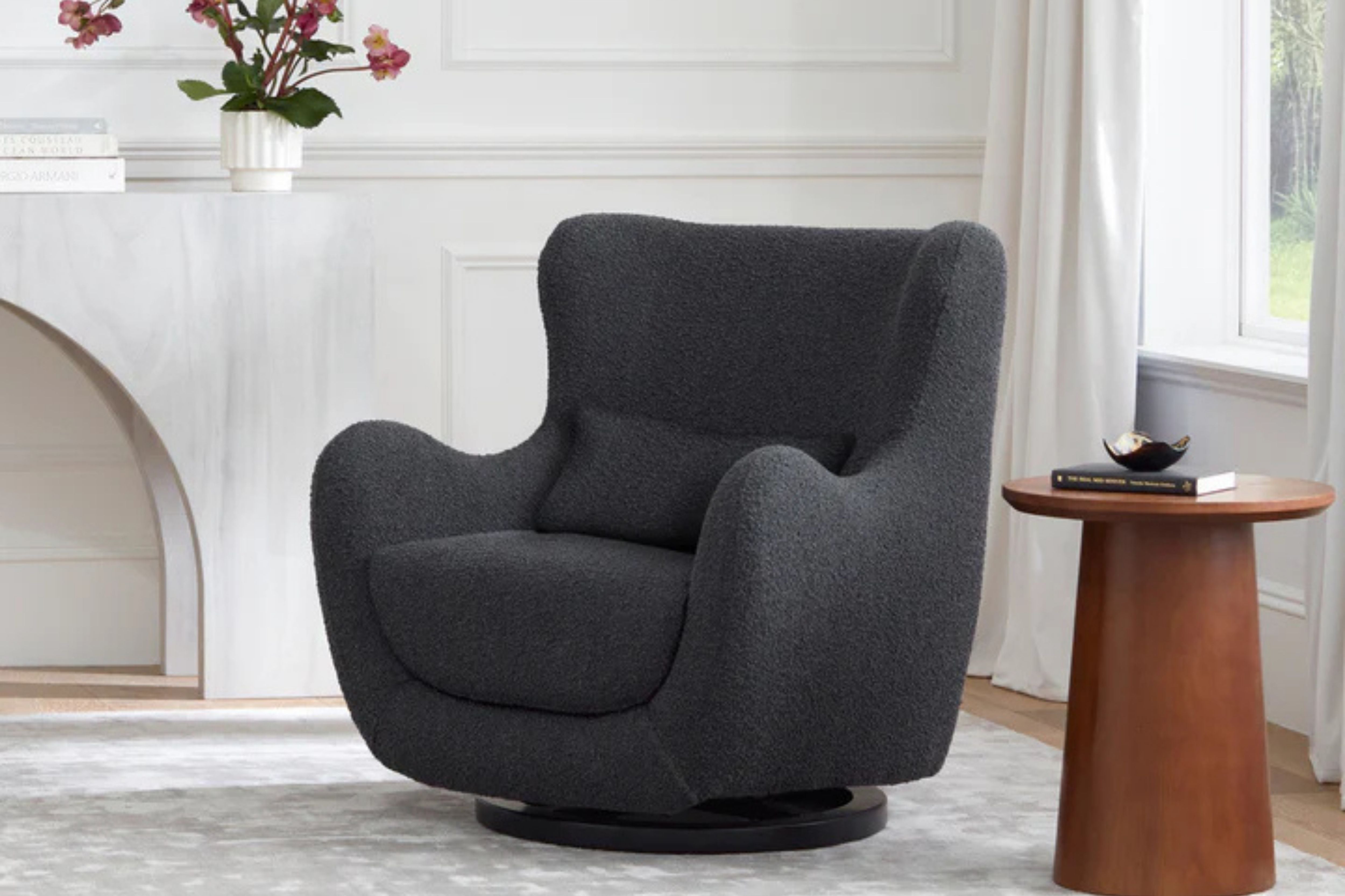 Nursery works solstice swivel glider black boucle displayed in a room#color_black-boucle-with-black-wood-base