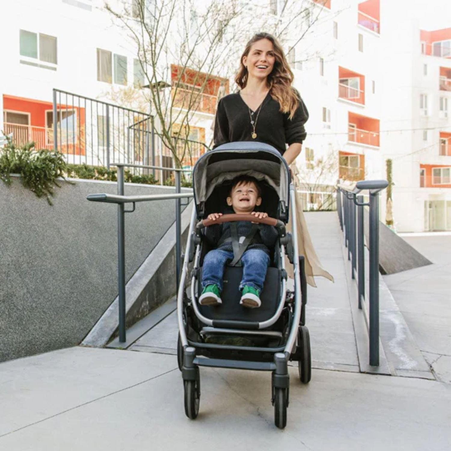 Mother walking her baby with the Uppababy Cruz 2 Gwen Reversible Stroller