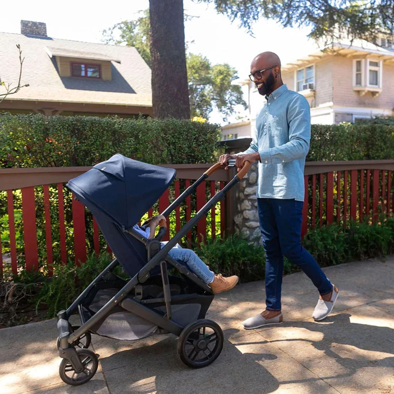 Father pushing baby in the Uppababy Cruz 2 Noa Reversible Stroller