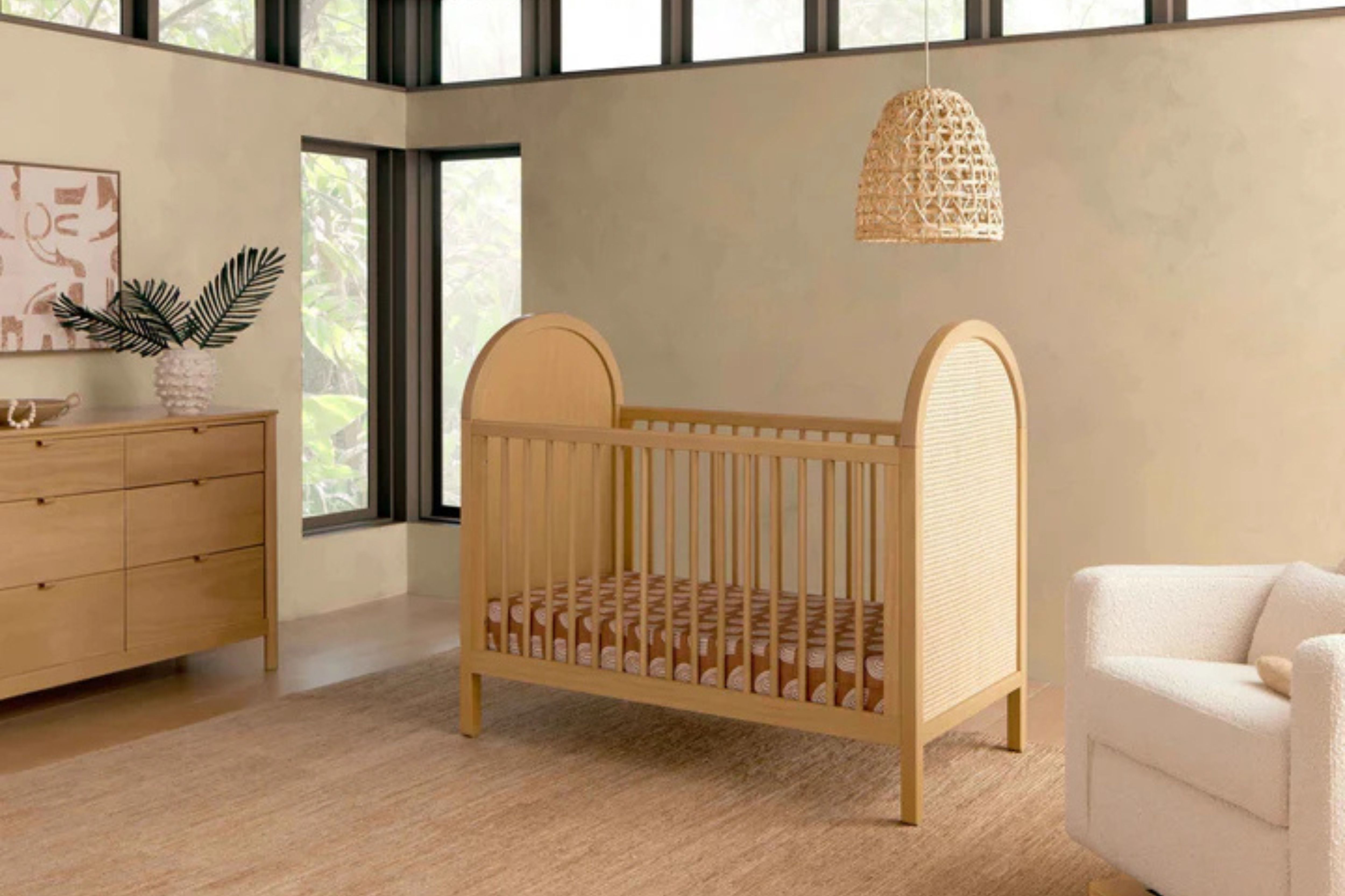 Babyletto Bondi Convertible Crib In Honey with natural cane displayed in a nursery#color_honey-with-natural-cane