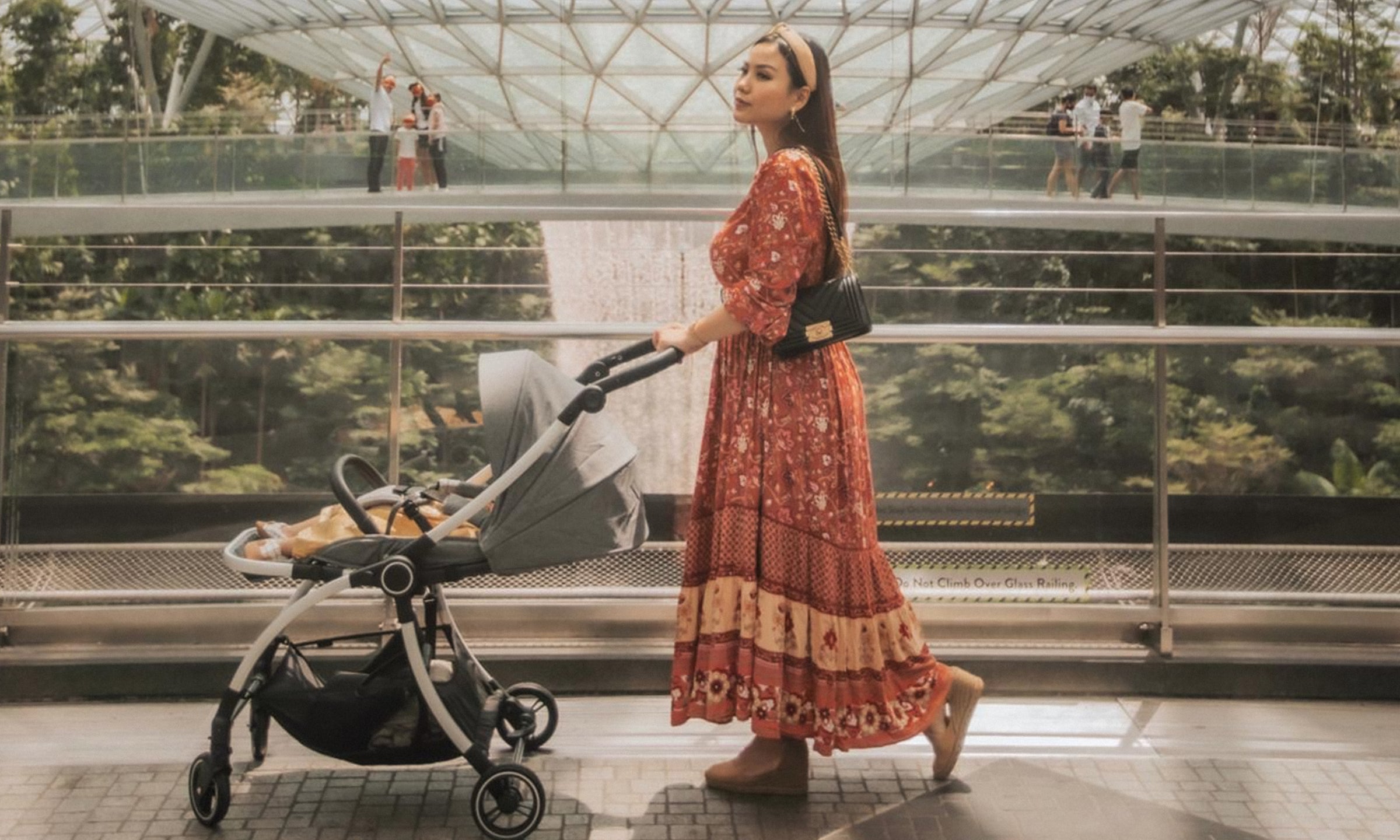 mum pushing baby in mall with lightweight travel reversible city stroller