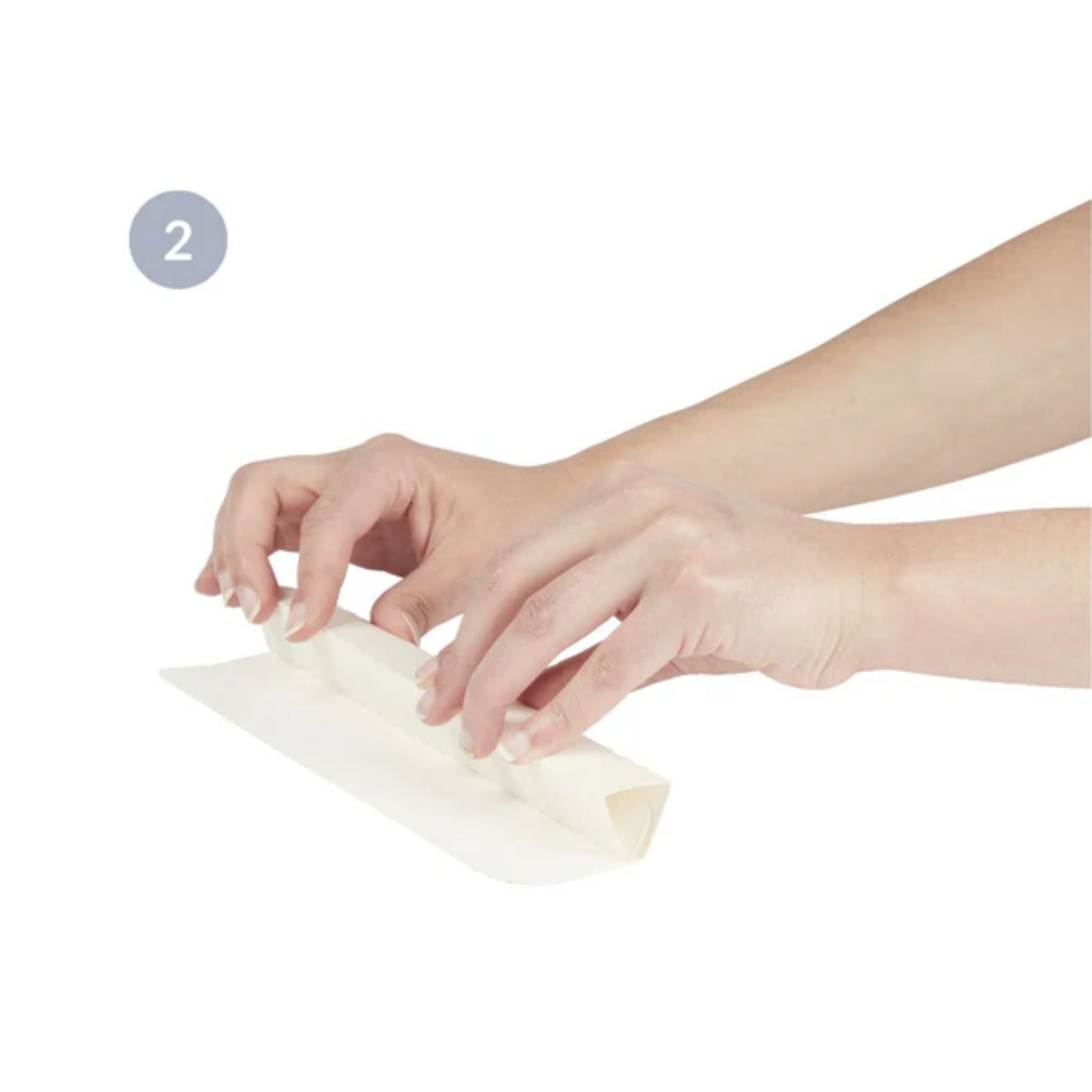 hands rolling up a piece of paper to transfer microballs from the doomoo refill bag